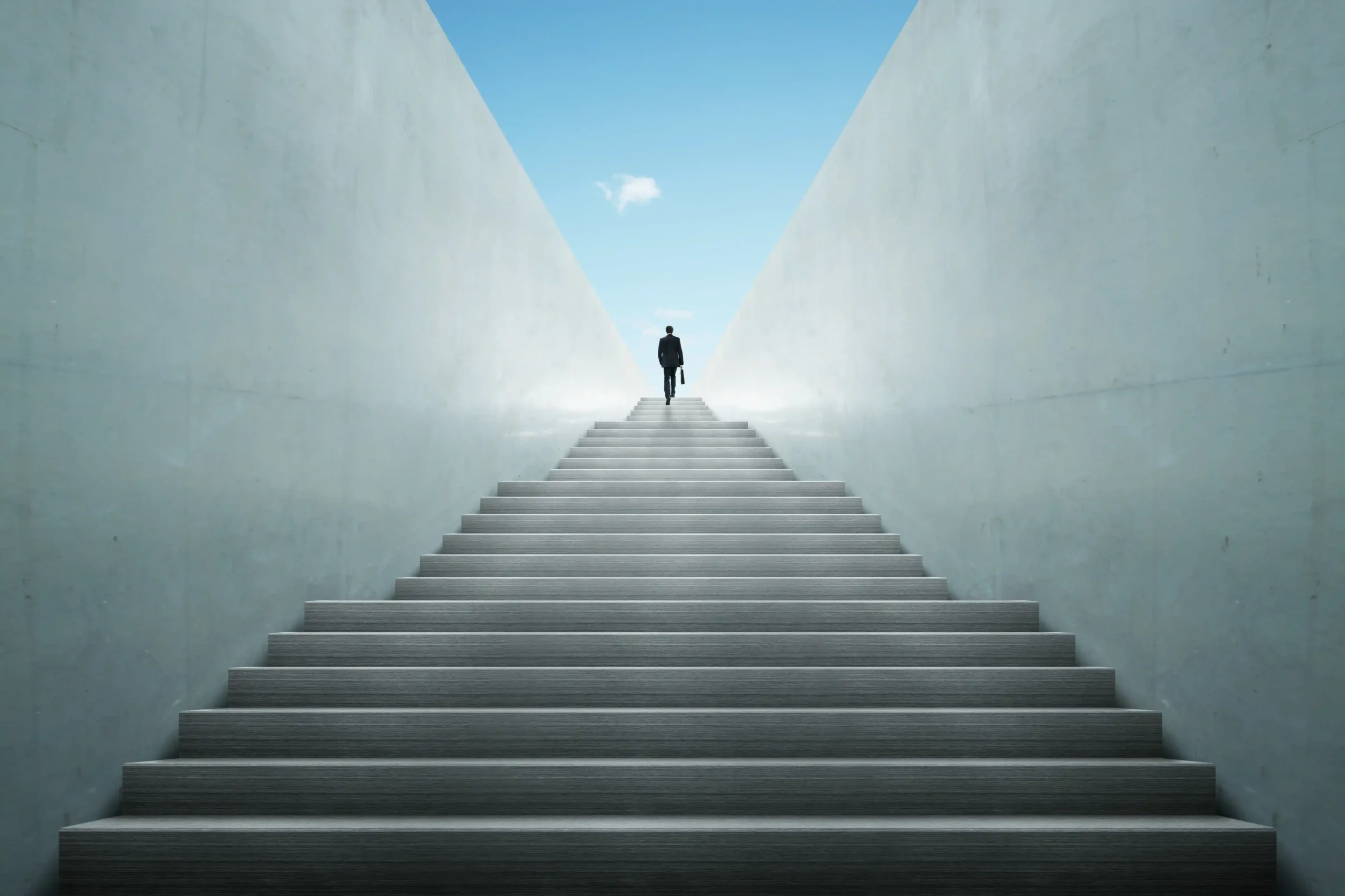 Silhouette of a man climbing a staircase